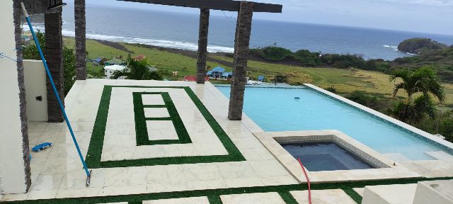 The same clifftop infinity pool with clear blue water after treatment